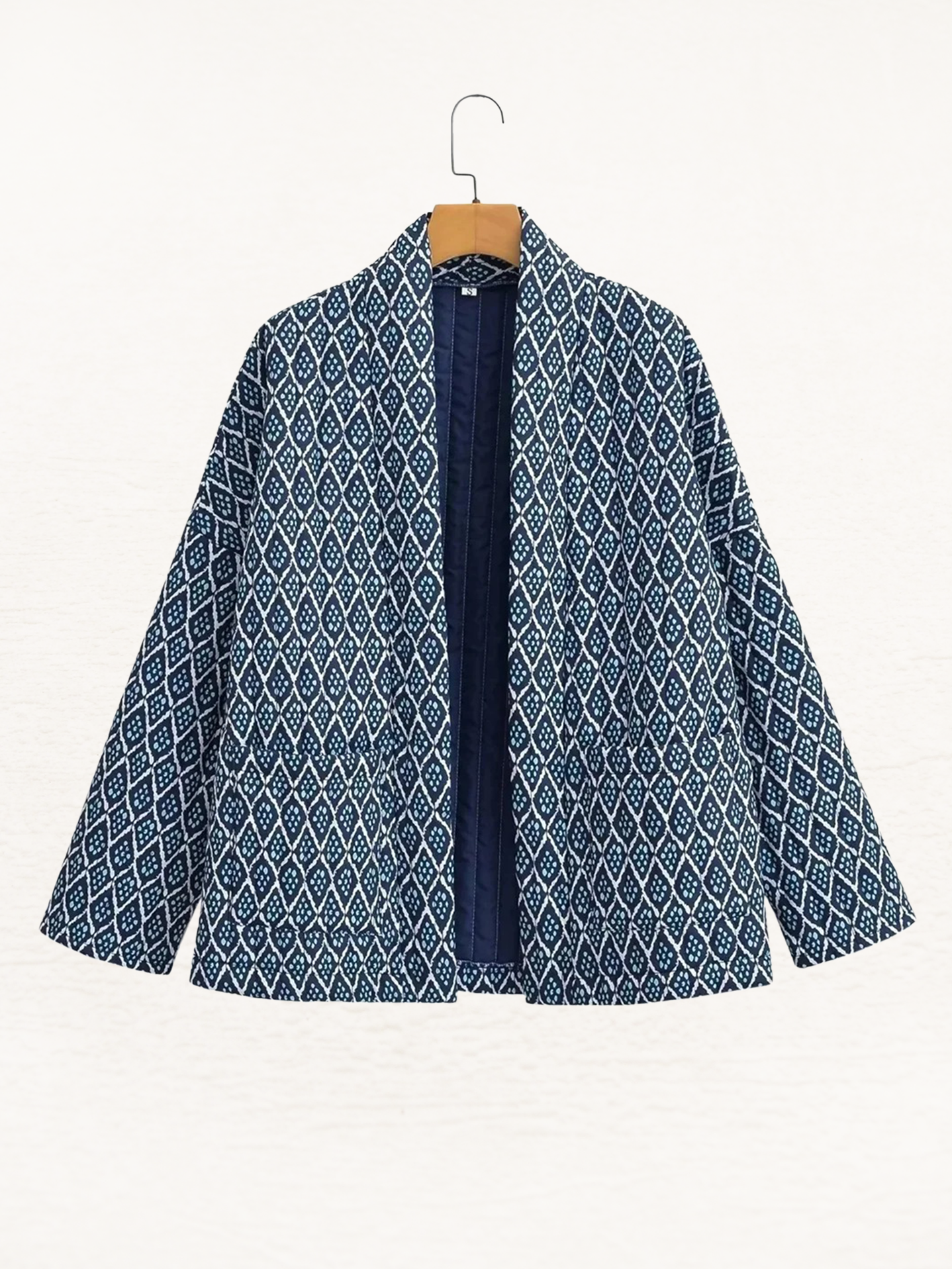 Women's jacket with blue and white pattern, hanging front view