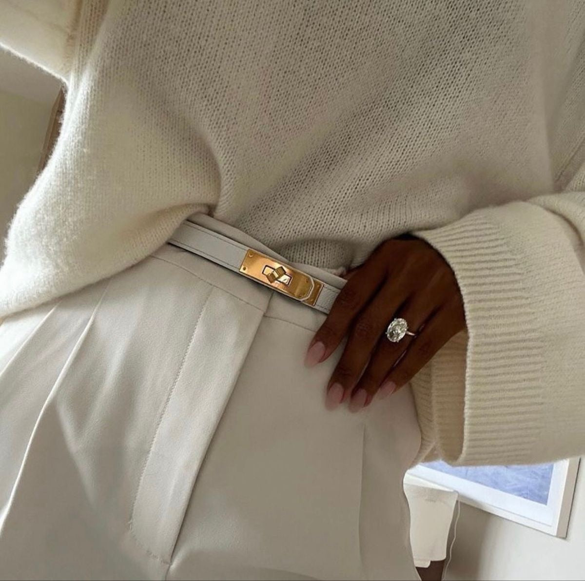 White leather belt with gold buckle worn with white dress