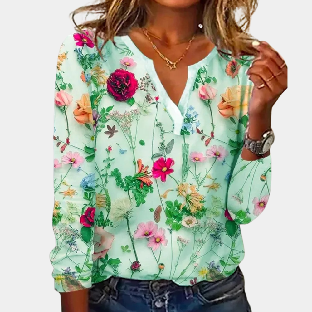 Blouse with colorful floral pattern, light green background, front view