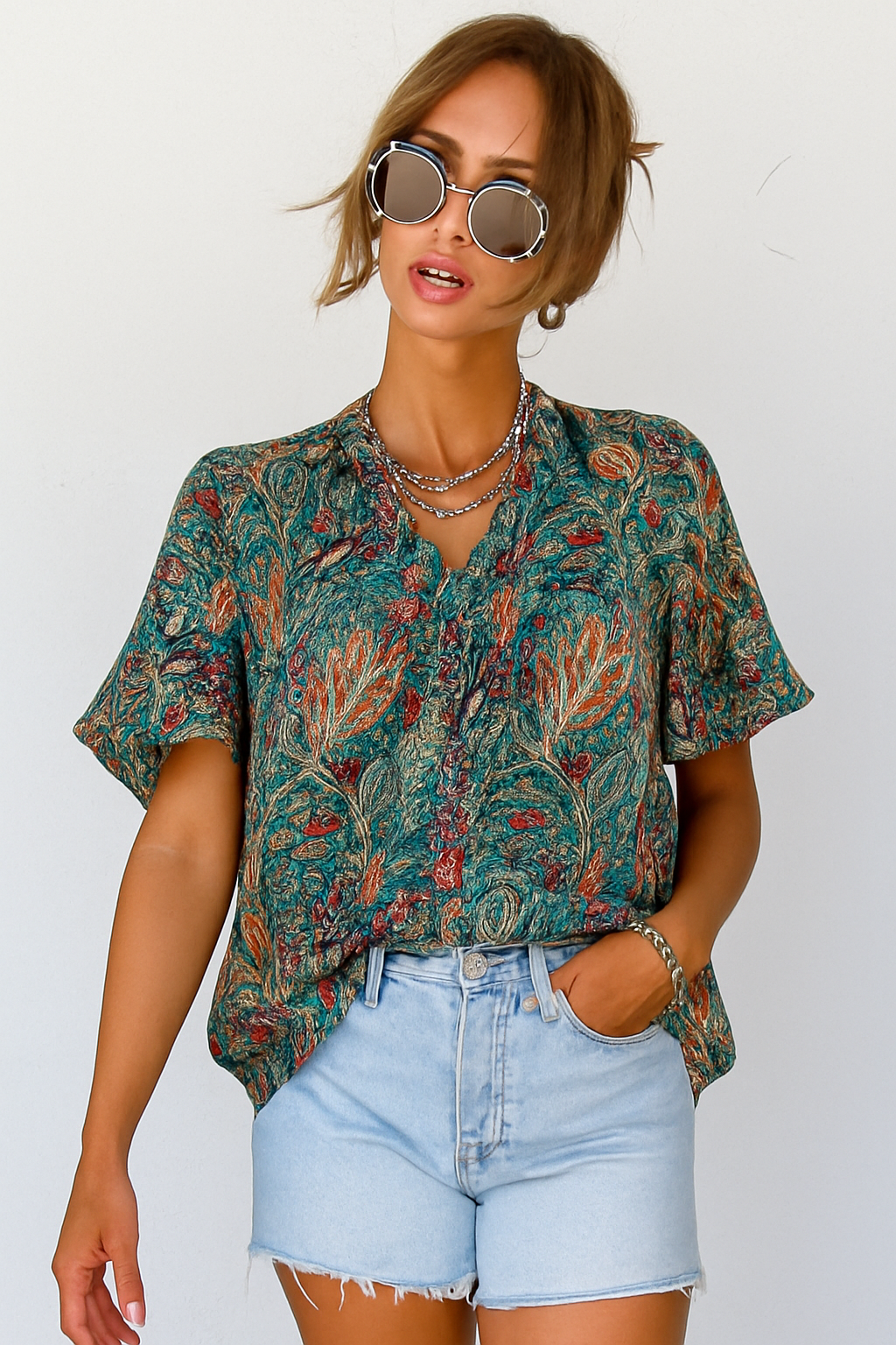 Blouse featuring vibrant paisley design, short sleeves, front view