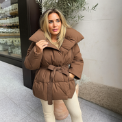 Brown puffer jacket with oversized collar and belt side view