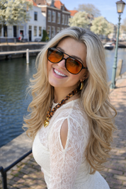 Model wearing black frame orange lens sunglasses side view