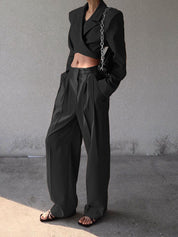 Black cropped blazer and wide-leg pants side profile