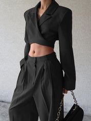 Black cropped blazer and wide-leg pants upper body close-up