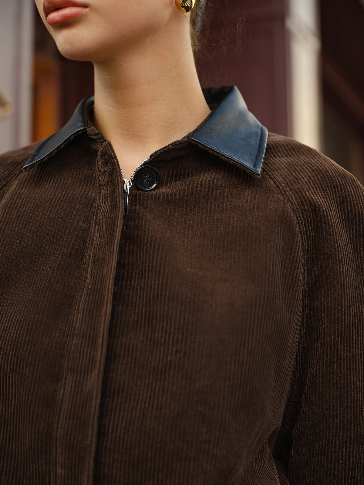 Brown corduroy jacket collar and zipper detail close-up