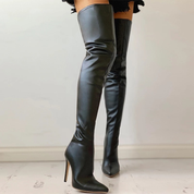 Black overknee boots worn with high heels side view