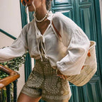 High-waist paisley shorts khaki side view with white blouse