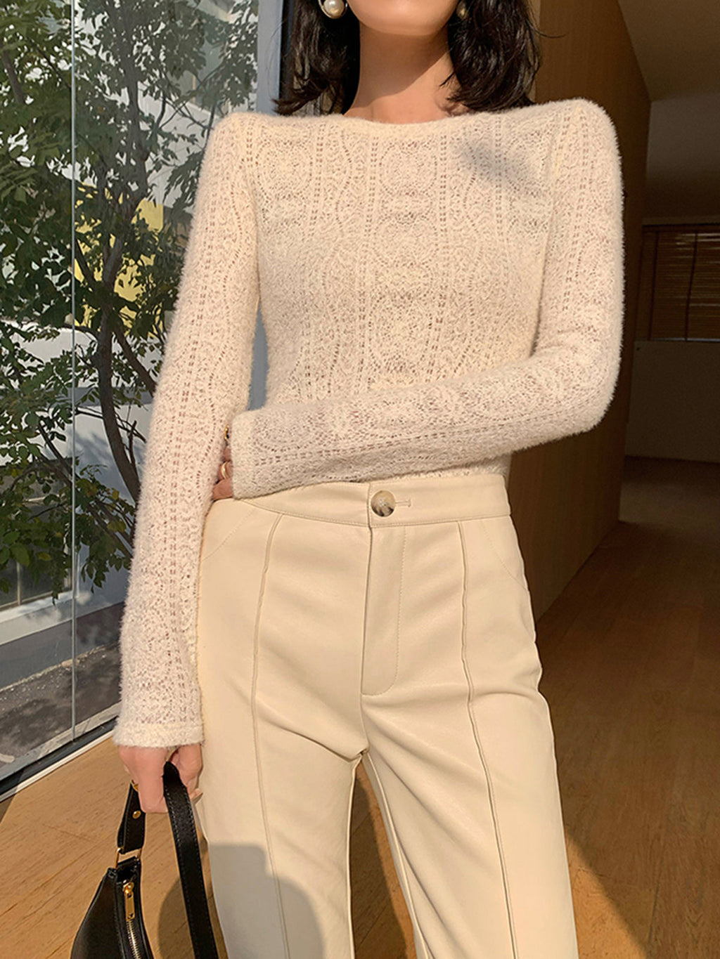 Cream knit top with openwork pattern close-up