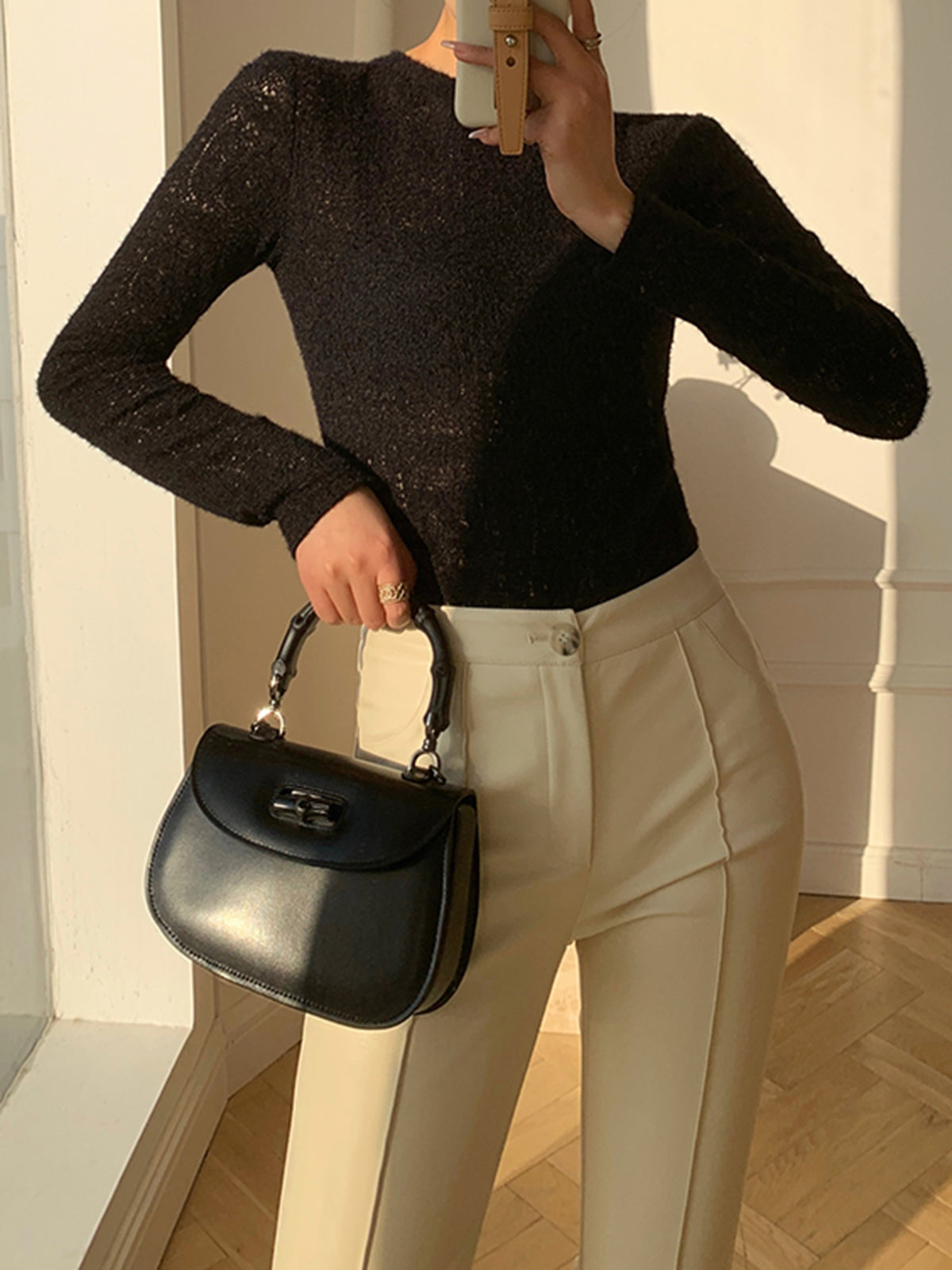 Black knit top with openwork pattern front view