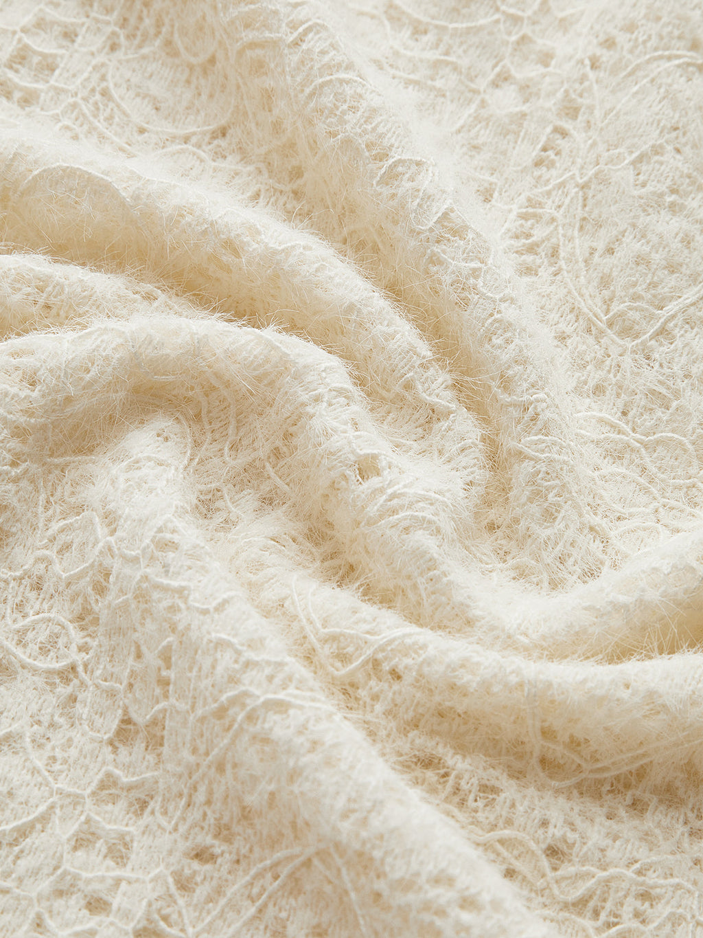 Cream knit top with openwork pattern texture close-up