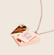 Rose gold envelope locket necklace open view with 'Love You' tag