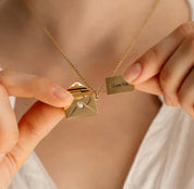 Gold envelope locket necklace held open with 'I Love You' tag
