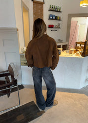 Cropped silhouette jacket brown back view with hands in pockets