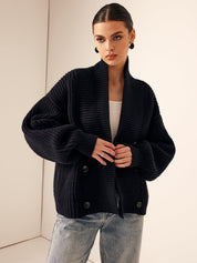 Black chunky knit cardigan with high collar hands on hips