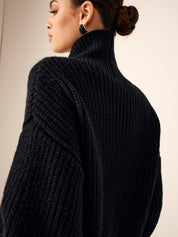 Side view of black chunky knit cardigan with high collar