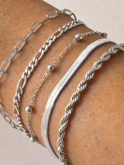 Silver armband set with various chain styles worn on wrist