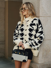 Women's cardigan with black and white houndstooth pattern, front view with handbag