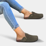 Olive suede clogs worn with jeans