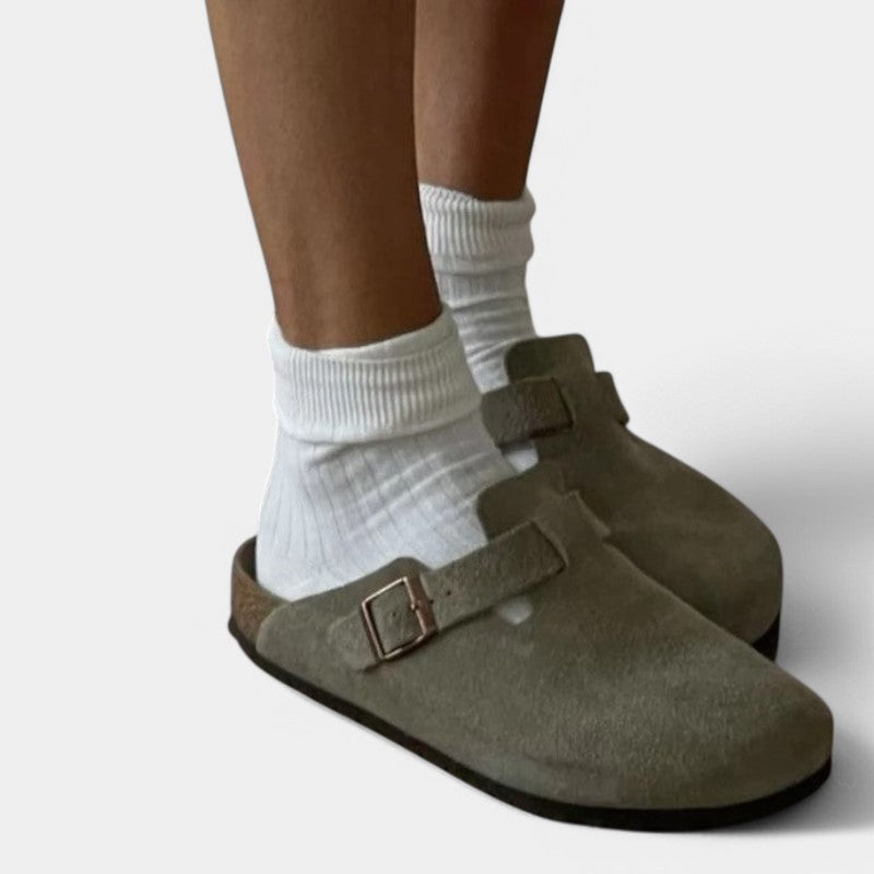 Beige suede clogs worn with white socks
