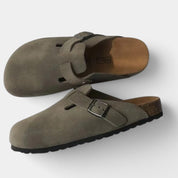Gray suede clogs with buckle front view