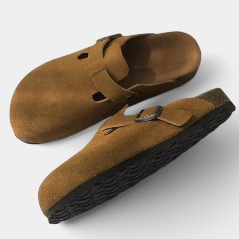 Brown suede clogs with buckle front view