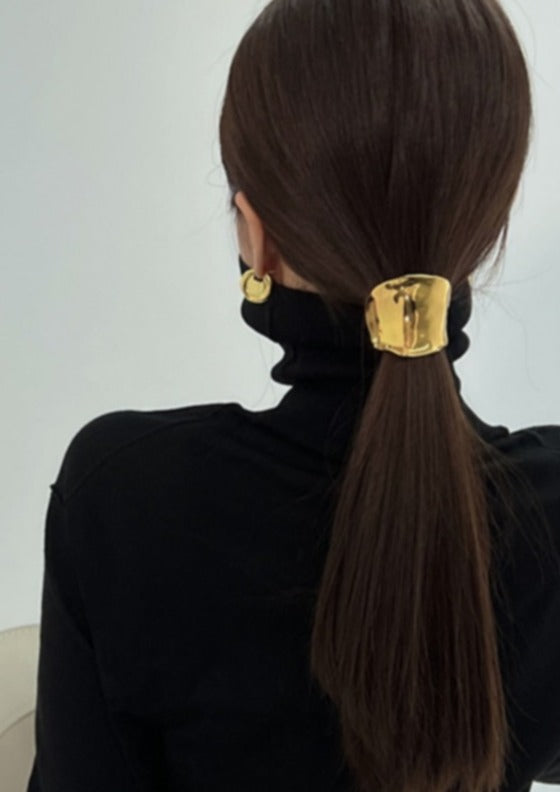 Gold hair cuff with organic texture, worn on ponytail, close-up back view