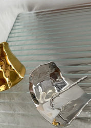 Silver hair cuff with hammered organic texture, close-up side view