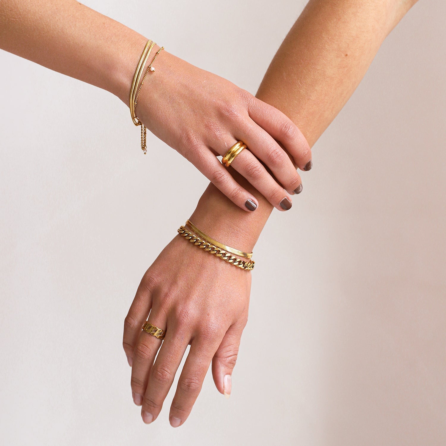 Gold-colored snake chain bracelet with extender, wrist detail