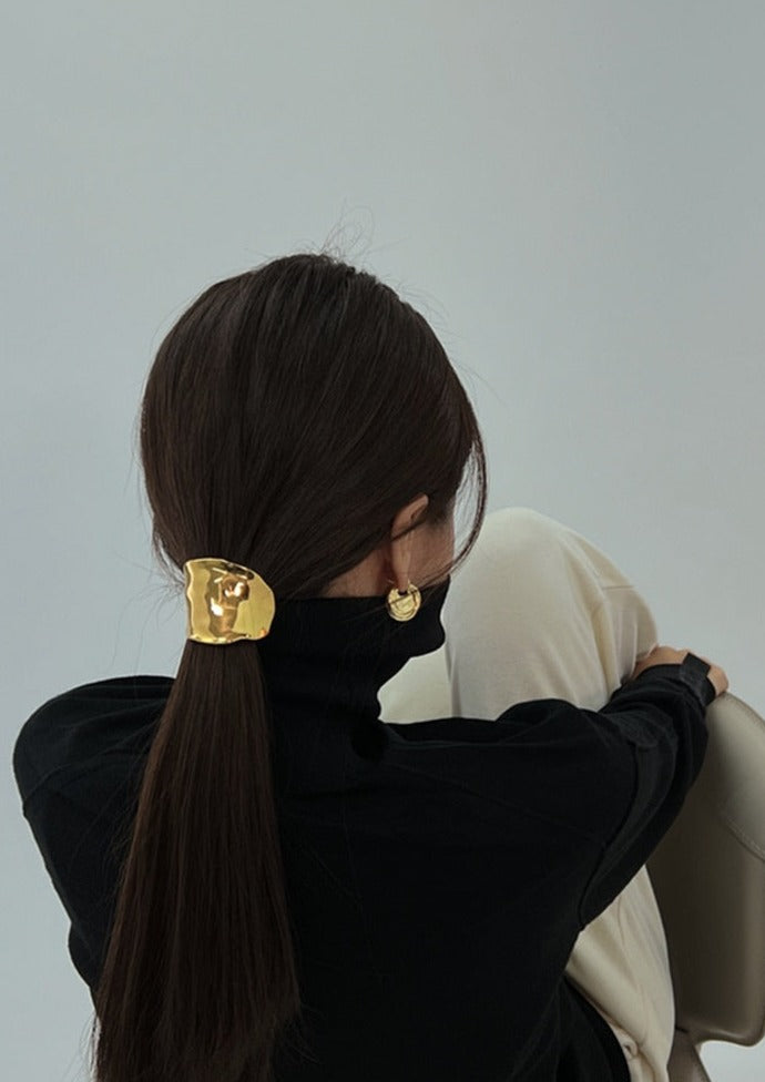 Gold hair cuff with organic texture, worn on ponytail, angled back view