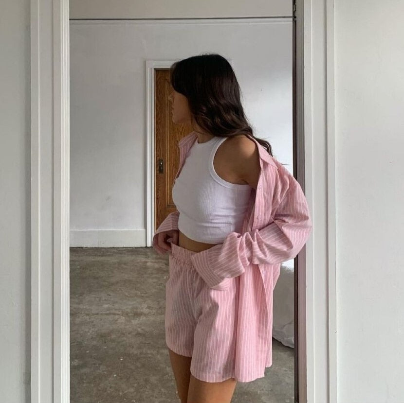 Pink striped shirt and shorts set indoor side view