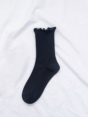 Black ruffled ankle sock single flat lay close-up