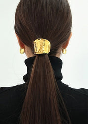 Gold hair cuff with organic texture, worn on ponytail, back view