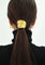 Gold hair cuff with organic texture, worn on ponytail, back view