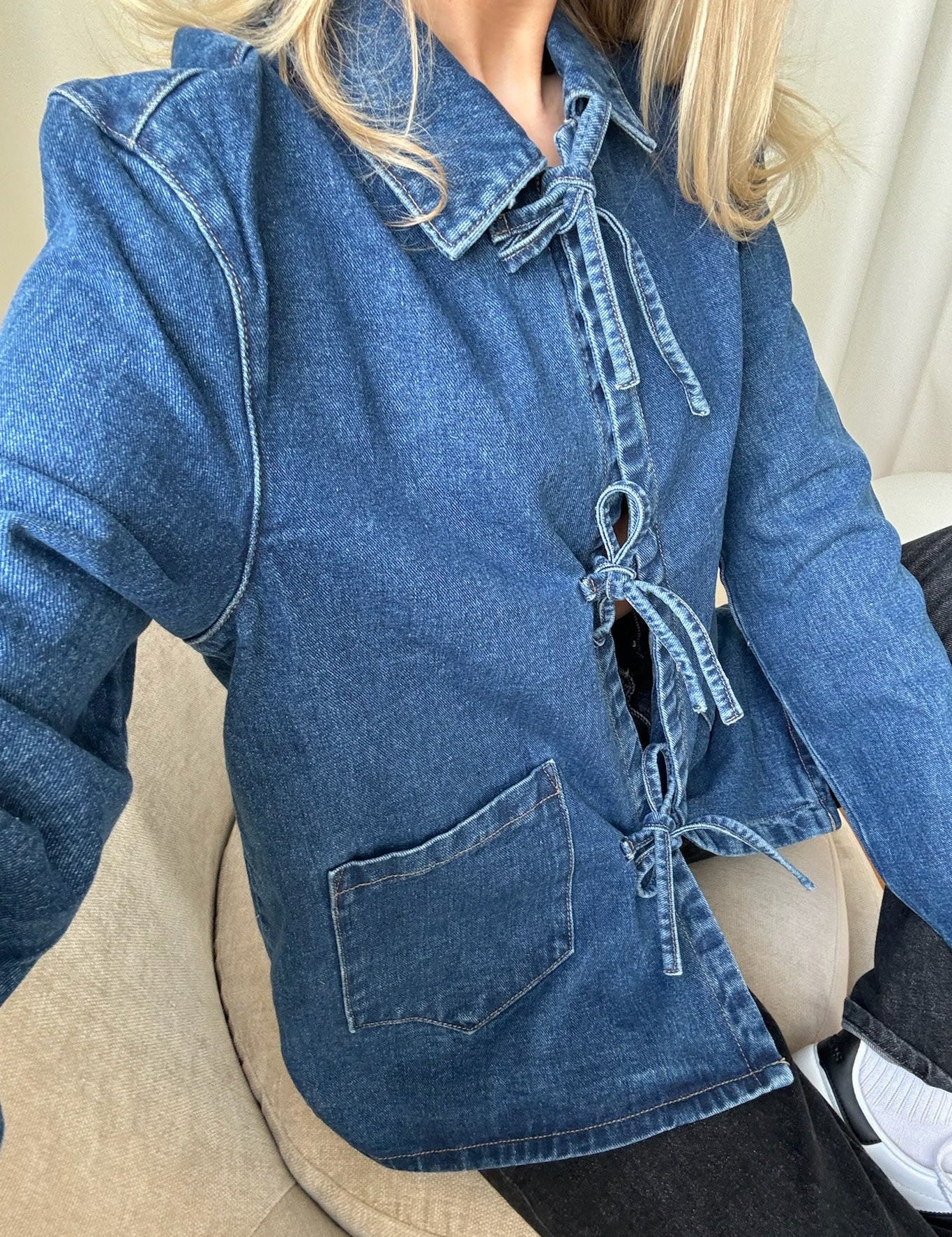 Close-up of denim jacket tie front detail