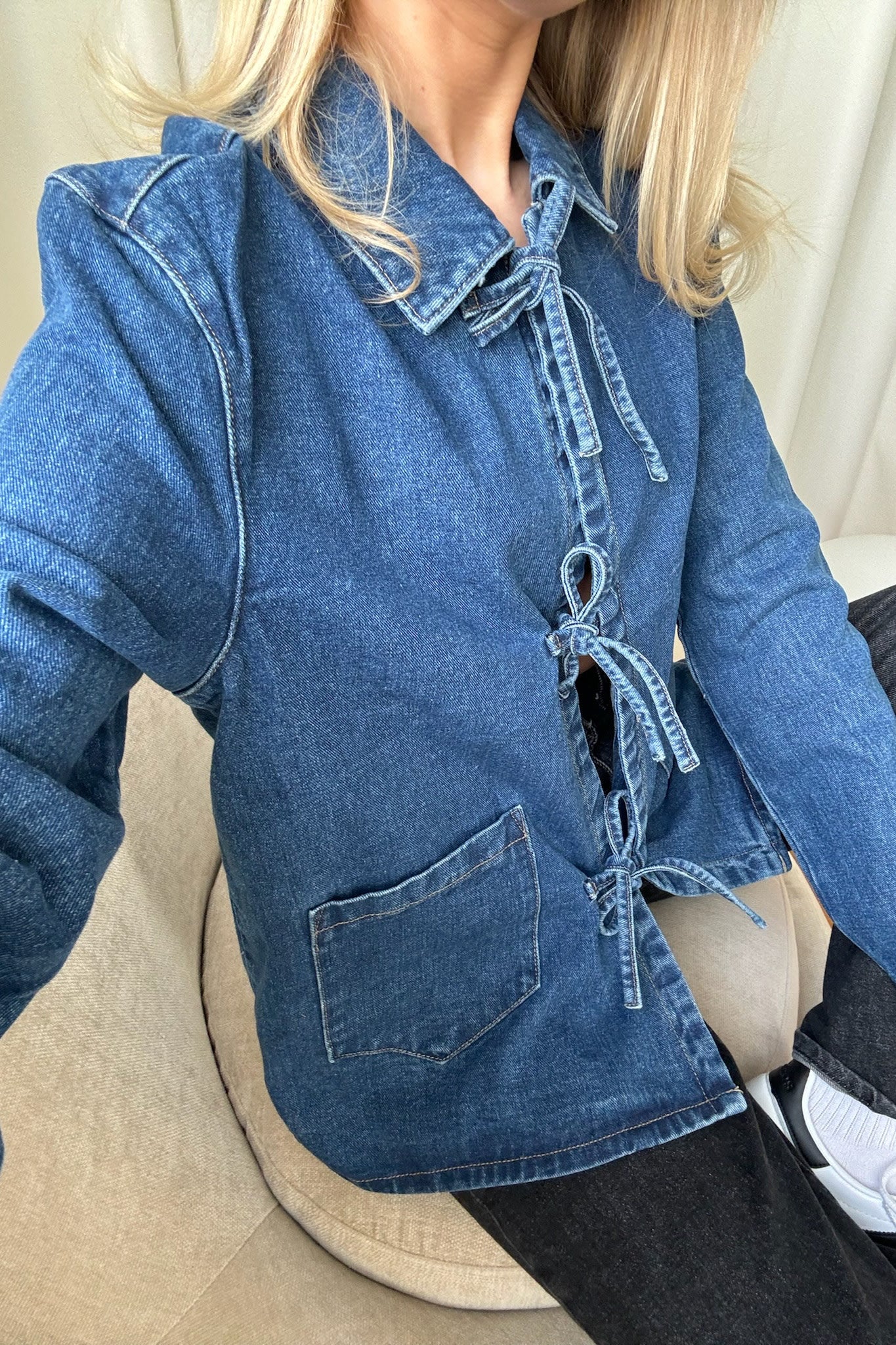 Close-up of denim jacket tie front detail