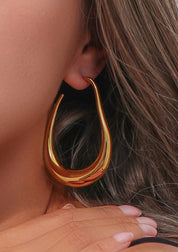 Gold teardrop hoop earring close-up