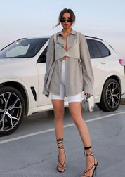 Woman wearing pearl grid bralette with blazer and shorts full body view