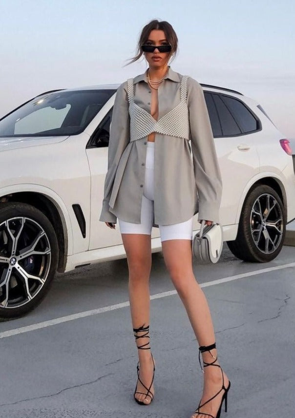 Woman wearing pearl grid bralette with blazer and shorts full body view