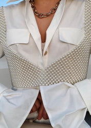 Pearl grid bralette worn under white blazer with chain necklace close-up view