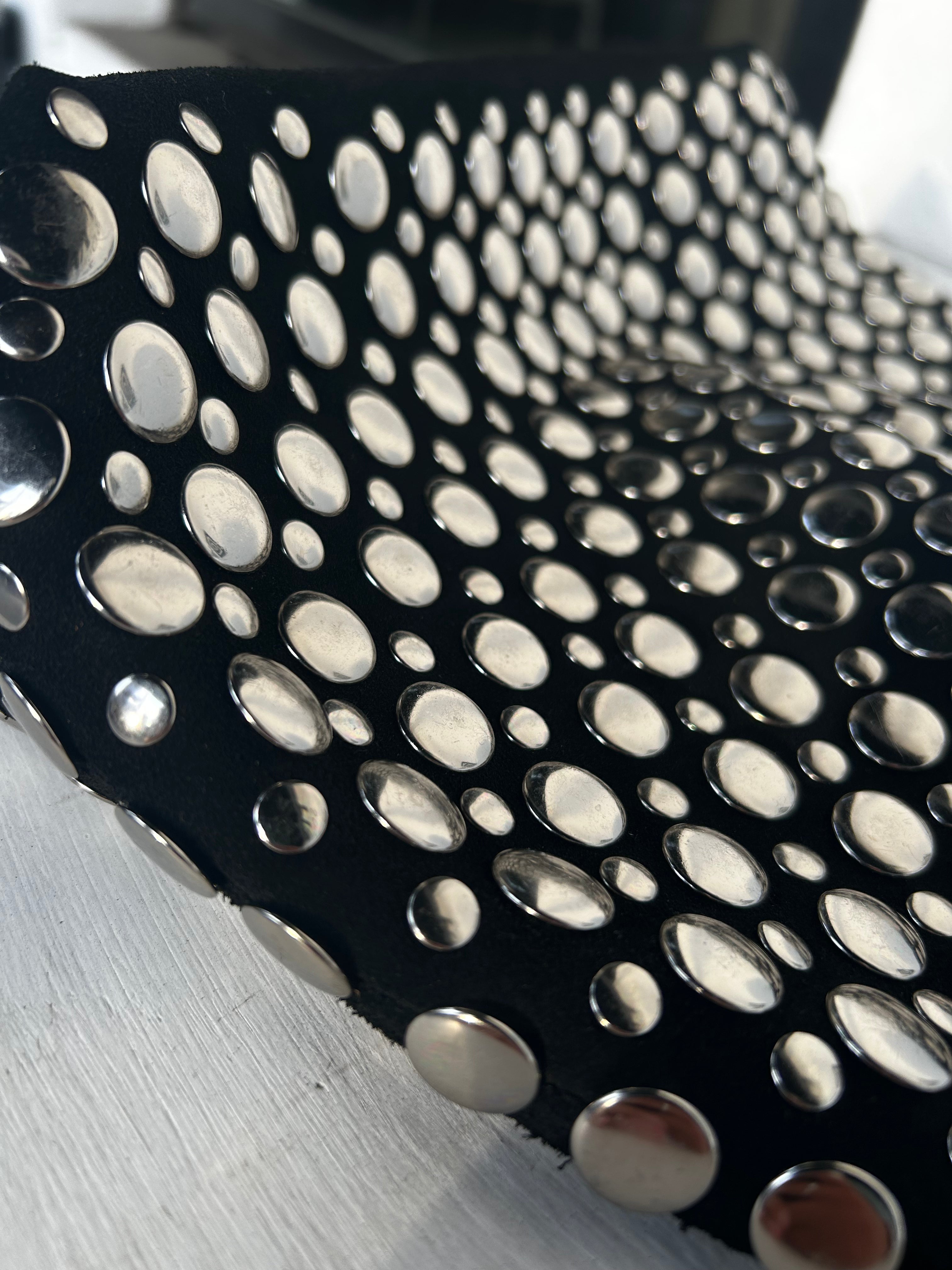 Close-up of silver studs on black hobo bag