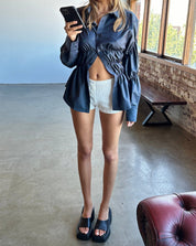 Blouse with ruched detailing and puff sleeves, front view with black pants