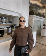 Brown blazer and skirt set with black pants indoor view