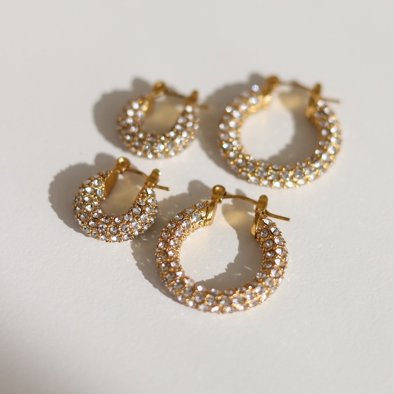 Gold hoop earrings with pave crystals angled view