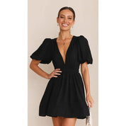 Black dress with deep V-neck and puffed sleeves front view