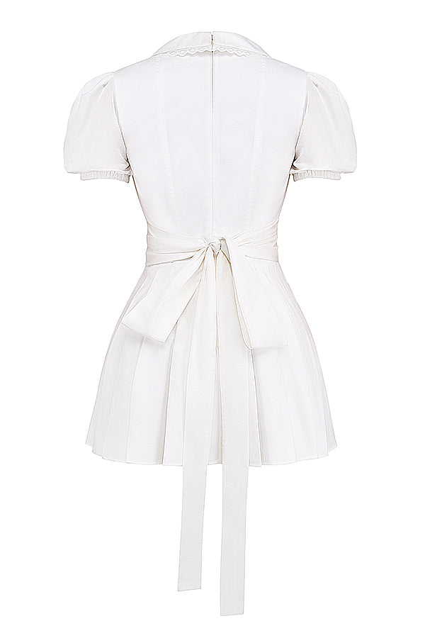 White mini dress with V-neck and pleated skirt isolated back view