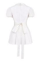 White mini dress with V-neck and pleated skirt isolated back view