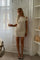 Cream dress with one-shoulder design, front view
