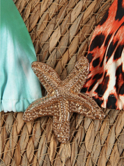 Starfish clasp detail on bikini top, close-up