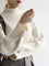 Cream sweater with balloon sleeves and ribbed texture, front view