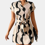 Abstract print dress black and beige front view with handbag